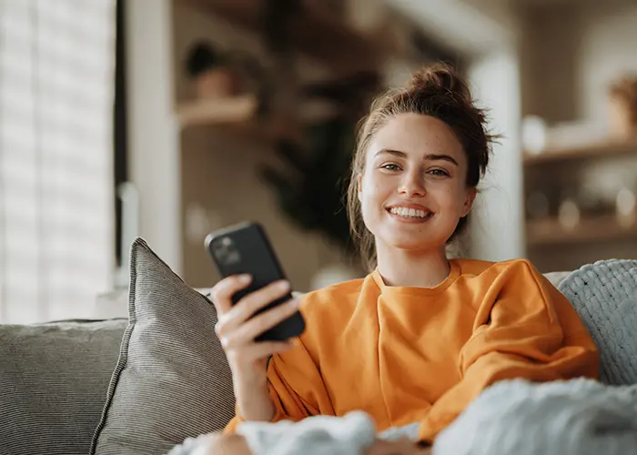 smiling woman holding phone
