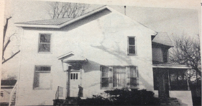 Old photograph of the original bank building for Iroquois Federal